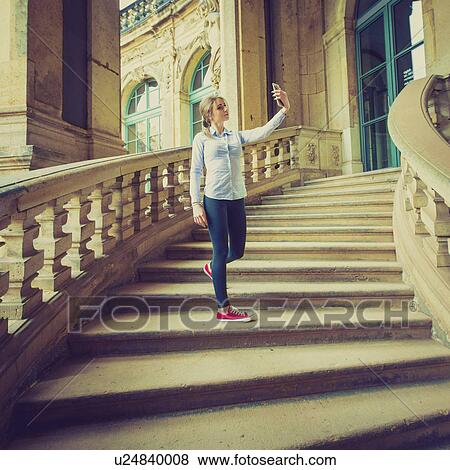 Young woman taking photo of herself View Large Photo Image Stock Photo - Young woman taking photo of herself. Fotosearch