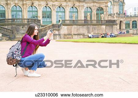 Young woman taking photo View Large Photo Image Stock Photograph - Young woman taking photo. Fotosearch