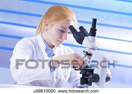 Young woman using microscope View Large Photo Image Stock Image - Young woman using microscope. Fotosearch