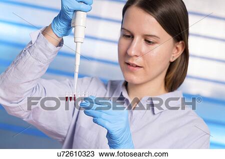 Young woman using pipette View Large Photo Image Stock Image - Young woman using pipette. Fotosearch