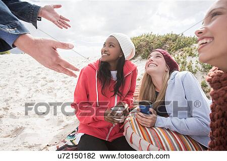 Young women and man picnicking on beach, Western Cape, South Africa View Large Photo Image Stock Image - Young women and man picnicking on beach, Western Cape, South Africa. Fotosearch