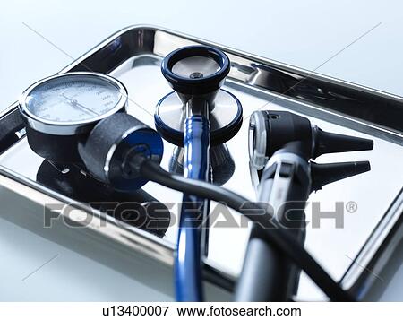 Stock Photo - Close-up of a sphygmomanometer, stethoscope and otoscope on a metal tray.. Fotosearch
