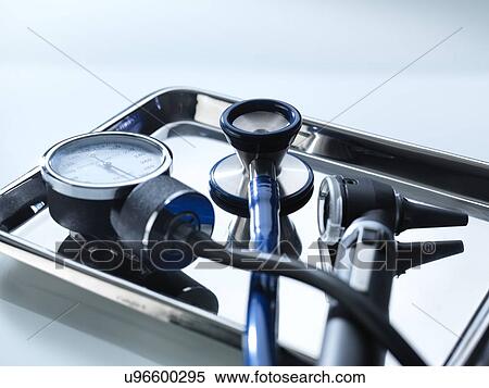 Stock Photography - Close-up of a sphygmomanometer, stethoscope and otoscope on a metal tray.. Fotosearch