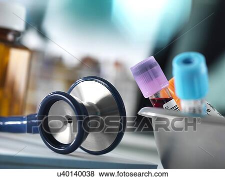 Stock Photo - Close-up of blood samples and a stethoscope on a doctor's desk.. Fotosearch