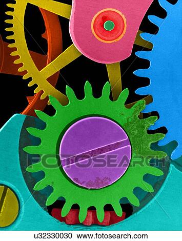Stock Image - Coloured scanning electron micrograph (SEM) of Watch cogs and gears from a 7 jewelled watch escapement. The red area is a ruby jewel used in a bearing. An escapement is a device within a watch that provides periodic impulses to the balance wheel that.... Fotosearch