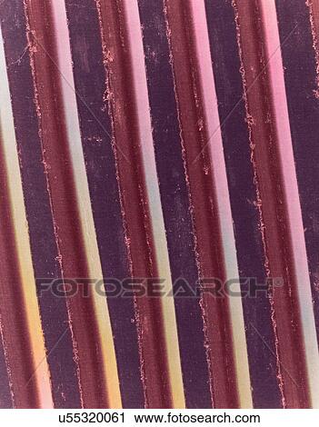 Stock Image - Coloured scanning electron micrograph (SEM) of Surface recording grooves of a 78 rpm phonograph record. Early disc phonograph records (also called gramophone records) were made of various materials including hard rubber. From 1897 onwards, earlier.... Fotosearch