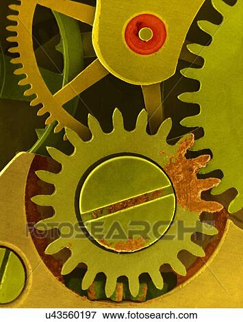 Stock Photo - Coloured scanning electron micrograph (SEM) of Watch cogs and gears from a 7 jewelled watch escapement. The red area is a ruby jewel used in a bearing. An escapement is a device within a watch that provides periodic impulses to the balance wheel that.... Fotosearch