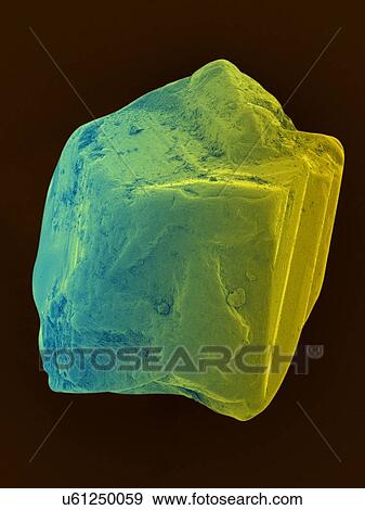Stock Photo - Coloured scanning electron micrograph (SEM) of an uncut sapphire. Sapphire is a typically blue gemstone variety of the mineral corundum (aluminium oxide). Sapphire is very dense and very hard. Non-gem quality sapphire is often used as an industrial.... Fotosearch