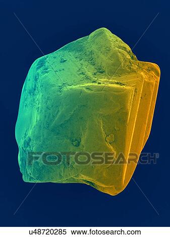 Stock Photography - Coloured scanning electron micrograph (SEM) of an uncut sapphire. Sapphire is a typically blue gemstone variety of the mineral corundum (aluminium oxide). Sapphire is very dense and very hard. Non-gem quality sapphire is often used as an industrial.... Fotosearch
