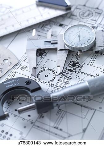 Stock Image - Drawing and measuring equipment on an engineering blue print.. Fotosearch