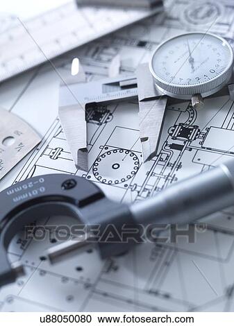 Stock Image - Drawing and measuring equipment on an engineering blue print.. Fotosearch