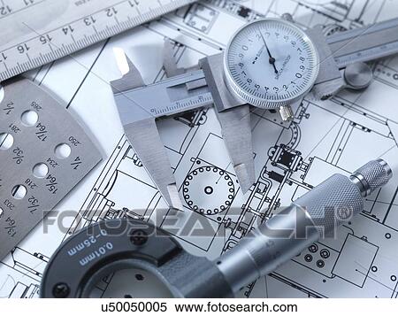 Stock Photography - Drawing and measuring equipment on an engineering blue print.. Fotosearch