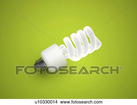 Picture - Energy saving lightbulb against a green background.. Fotosearch
