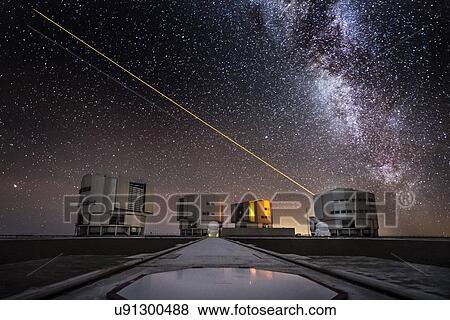 Stock Photo - Laser beam from the UT4 telescope in the sky above the Paranal ESO observatory in Chile with the milky way in the background.. Fotosearch