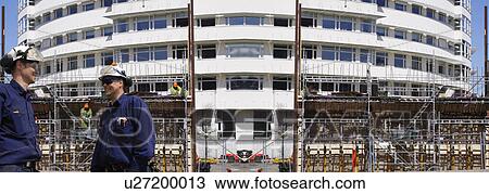 MODEL RELEASED. Construction workers on a site with new apartment building, panoramic. View Large Photo Image Stock Image - MODEL RELEASED. Construction workers on a site with new apartment building, panoramic.. Fotosearch
