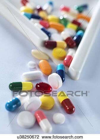 Pills pouring out of measuring triangle. View Large Photo Image Stock Image - Pills pouring out of measuring triangle.. Fotosearch