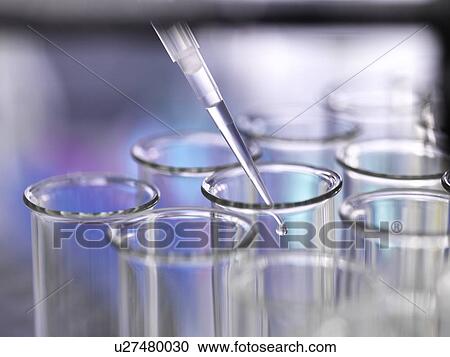 Stock Image - Sample being pipetted into a test tube.. Fotosearch