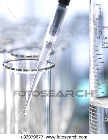 Stock Photo - Sample being pipetted into a test tube.. Fotosearch
