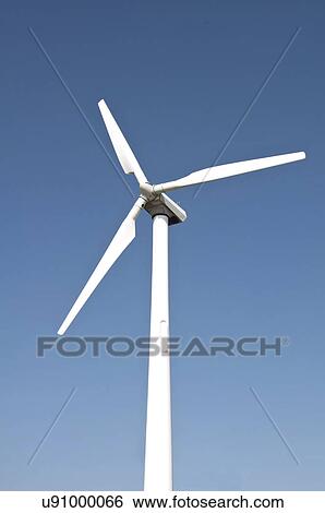 Stock Photograph - Wind turbine against blue sky.. Fotosearch