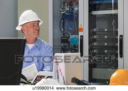 Picture - Electrical engineer at work. Fotosearch