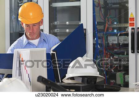 Picture - Electrical engineer at work. Fotosearch