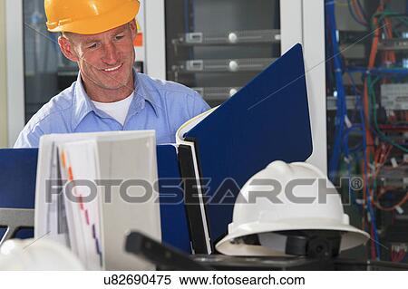 Stock Photography - Electrical engineer at work. Fotosearch