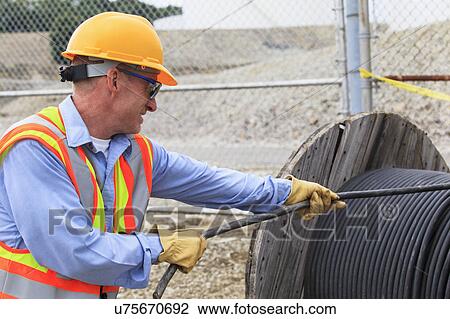 Electrical engineer pulling power cable from reel View Large Photo Image Stock Image - Electrical engineer pulling power cable from reel. Fotosearch