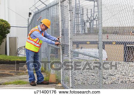 Stock Photograph - Electrical engineer using security system. Fotosearch
