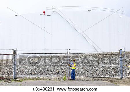 Engineer entering fuel storage tank depot View Large Photo Image Stock Image - Engineer entering fuel storage tank depot. Fotosearch