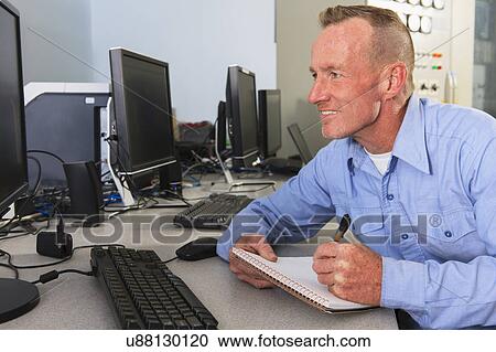 Stock Image - Engineer working in power plant. Fotosearch