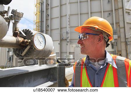 Stock Photo - Engineer working in power plant. Fotosearch