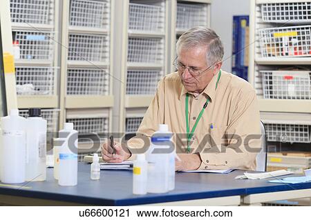 Stock Image - Engineering professor in chemistry laboratory. Fotosearch