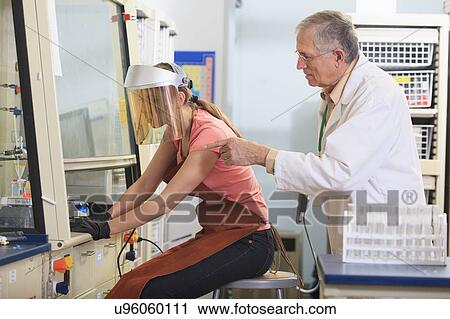 Stock Image - Engineering student in a chemistry laboratory. Fotosearch