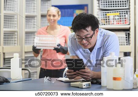 Stock Image - Engineering students in a chemistry laboratory. Fotosearch