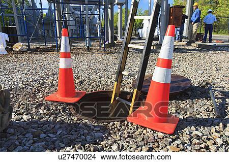 Ladder in manhole and warning cones View Large Photo Image Picture - Ladder in manhole and warning cones. Fotosearch