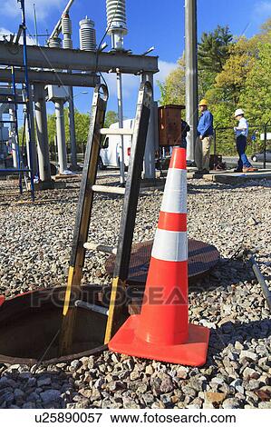 Ladder in manhole and warning cones View Large Photo Image Stock Photo - Ladder in manhole and warning cones. Fotosearch