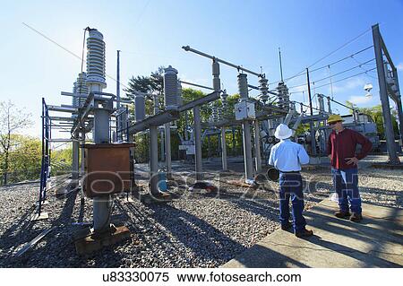 Stock Photography - Ladder in manhole and warning cones. Fotosearch