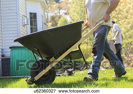 Stock Photo - Landscapers at work in garden. Fotosearch