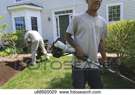 Stock Photo - Landscapers at work in garden. Fotosearch