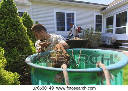 Stock Photo - Landscapers at work in garden. Fotosearch