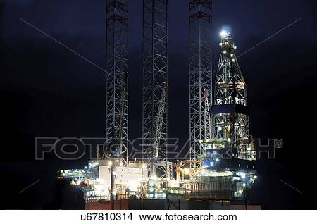 Oil rig at night View Large Photo Image Picture - Oil rig at night. Fotosearch