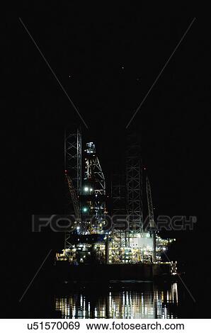 Oil rig at night View Large Photo Image Stock Photo - Oil rig at night. Fotosearch