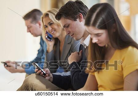 Picture - Passengers seated in an airport lounge. Fotosearch