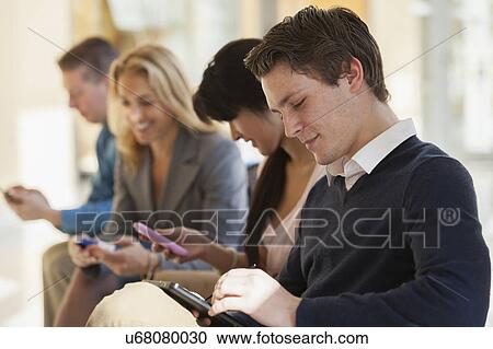 Passengers seated in an airport lounge View Large Photo Image Stock Image - Passengers seated in an airport lounge. Fotosearch
