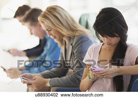 Passengers seated in an airport lounge View Large Photo Image Stock Image - Passengers seated in an airport lounge. Fotosearch