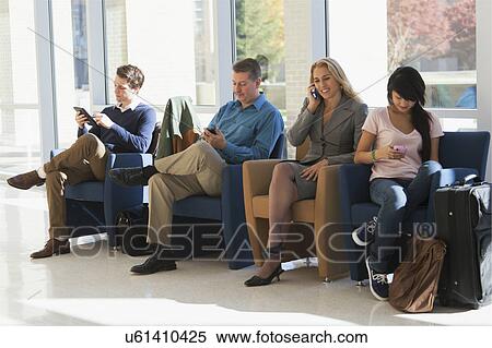 Passengers seated in an airport lounge View Large Photo Image Stock Photography - Passengers seated in an airport lounge. Fotosearch