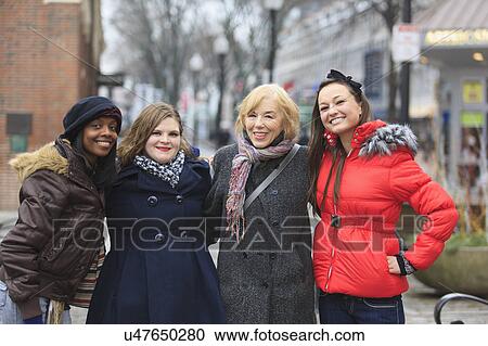 Stock Image - Portrait of four women smiling. Fotosearch