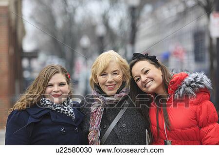 Stock Image - Portrait of three women smiling. Fotosearch
