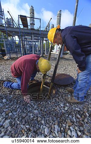 Picture - Power engineers at work. Fotosearch