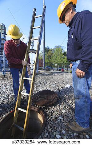 Picture - Power engineers at work. Fotosearch